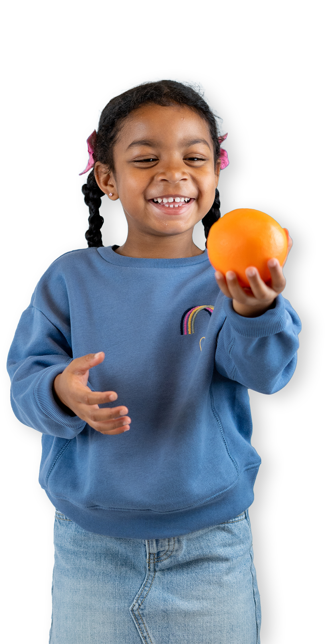 A young girl holding an orange.