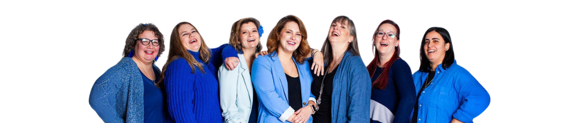 Group of adults wearing shades of blue smiling at camera