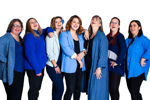 Group of adults wearing shades of blue smiling at camera