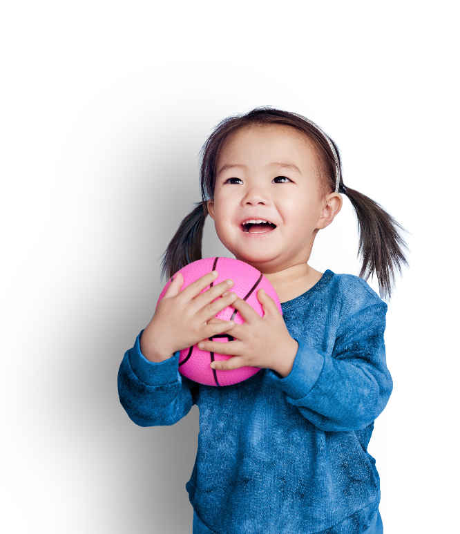 Little girl with pigtails wearing blue dress and holding pink ball