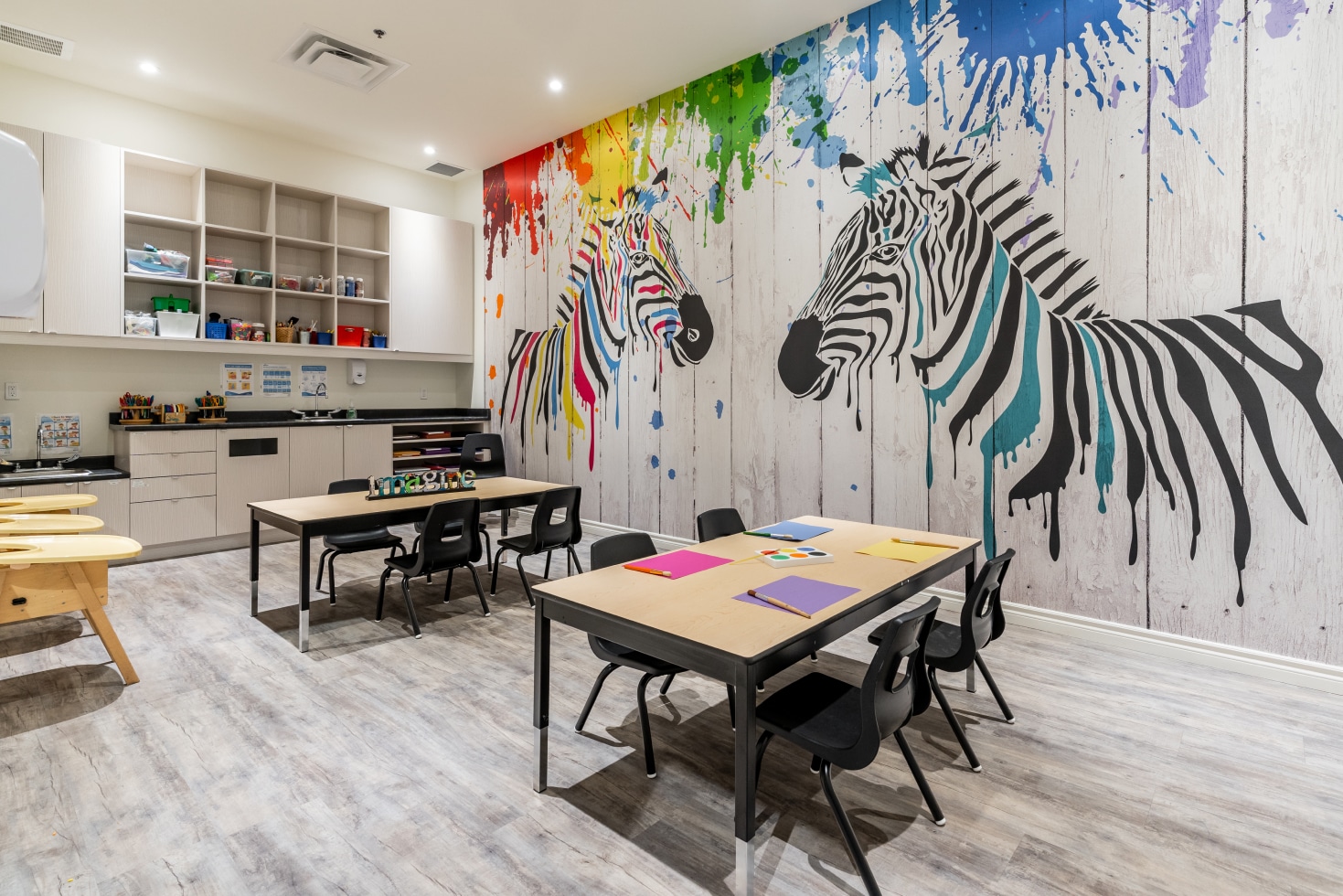 An early learning centre with zebras painted on the wall in the children's room.
