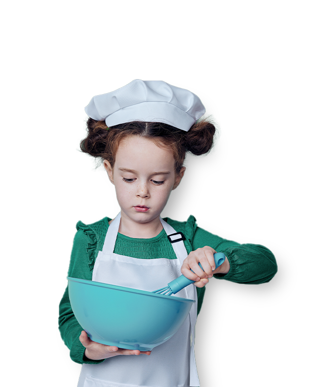 Child wearing an apron holding a mixing bowl