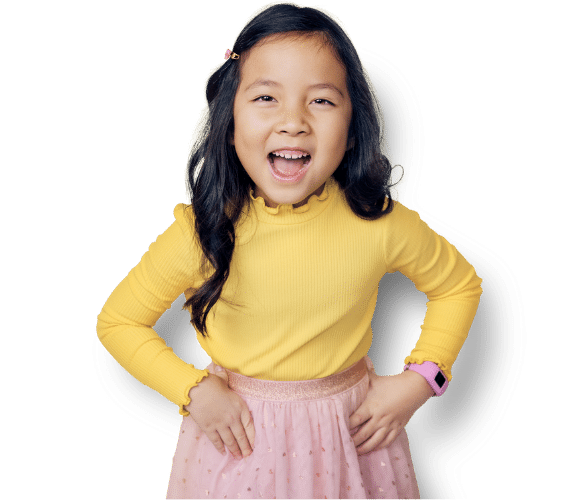 Girl wearing yellow shirt and pink skirt with hands placed on her waist