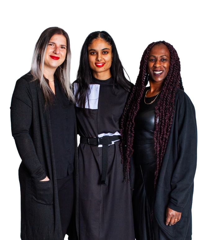 Three educators wearing black standing together smiling at camera