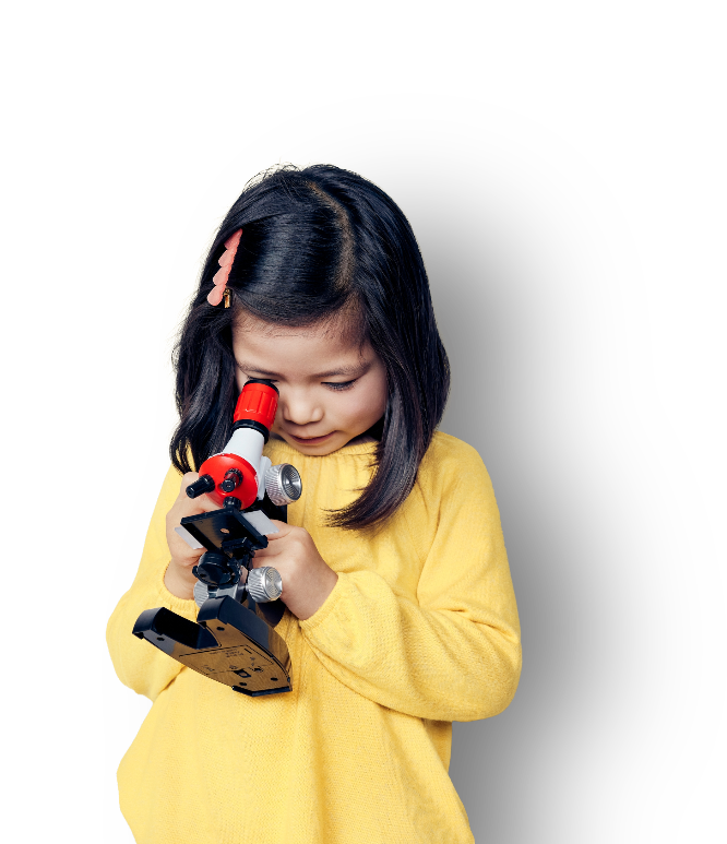 Girl holding and looking into microscope
